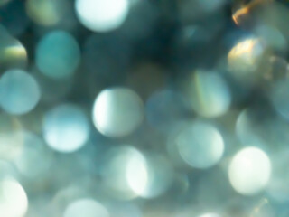 Obraz premium Abstract colorful Silver bokeh effect texture on black background. glitter vintage lights defocused elegant for Christmas or celebrate. Sparkling magical dust particles.