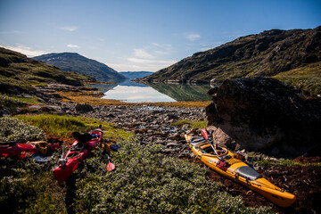 Kayak expedition between icebergs in Narsaq fiords, South West Greenland, Denmark
