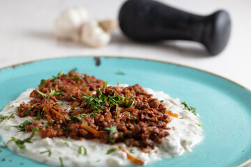 Turkish Sauteed Lamb Meat Served with Smoked Eggplant and Yogurt Puree, Garnished with Grilled Hot Pepper. Ali Nazik Kebab