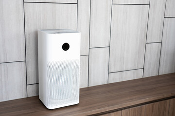 Indoor air purifier with digital monitor screen in living room, show air quality in the room and air pollution levels in the room. with wood laminate wall background