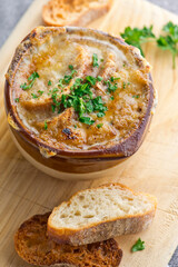 French Onion Soup. Classic traditional french restaurant bistro menu item. French onion soup, yellow onions reduced in broth topped with cheese melted and served with homemade baguettes. 