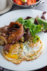 Omelette made with bacon, ham, sausage, bell peppers, heirloom tomatoes, spinach, onions, cheddar & Swiss cheese. Served with crispy potato hash, a classic American breakfast or brunch favorite.