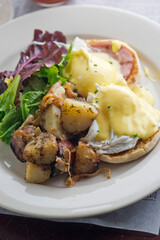 Omelette made with bacon, ham, sausage, bell peppers, heirloom tomatoes, spinach, onions, cheddar & Swiss cheese. Served with crispy potato hash, a classic American breakfast or brunch favorite.