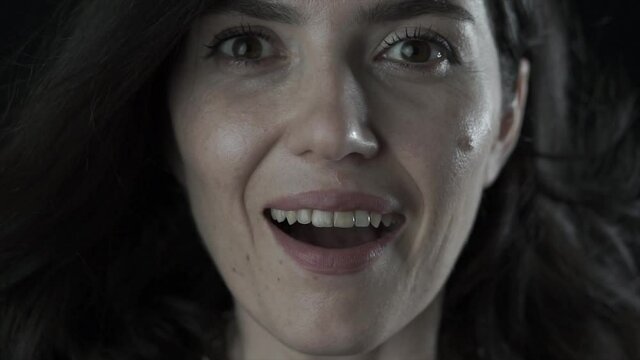 Close up face portrait of amazed, surprised, shocked beautiful young white Caucasian woman