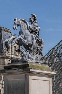 Equestrian statue of Louis XIV in main courtyard (Cour Napoleon) at the Paris Louvre Museum. PARIS, FRANCE. April 8, 2017.