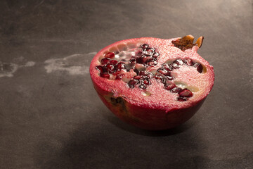 Pomegranate isolated on dark background. Studio shot