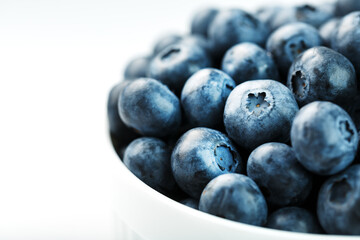 Blueberries in a white Cup on a white background. Isolate, free space