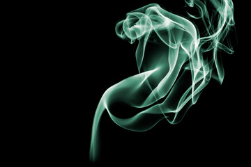 Green smoke isolated on black background.