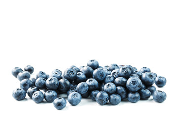 Tasty blueberries fruit are scattered on a white background.