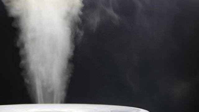 White steam of ultrasonic humidifier. Frume of vapor from diffuser for air moisturize. Loop endless video of smoke for humidity at home. Moisturizer and purifier of air. Diffused mist from inhaler.