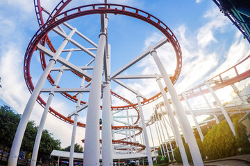 Roller coaster with sunset blue sky background