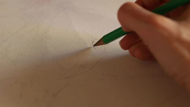Anonymous artist drawing into canvas with a pencil