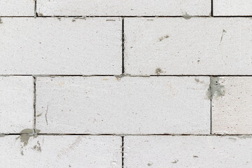 Smooth white brick wall with traces of cement background texture