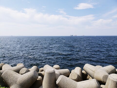 Scenic View Of Rocks By Sea Against Sky