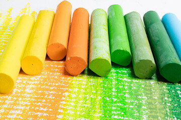 Multi-colored pastel crayons. Materials for drawing and creativity. Bright water-based paints. School supplies. Hobbies and creativity