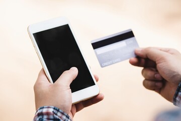 hands holding credit card and smart phone for online shopping.