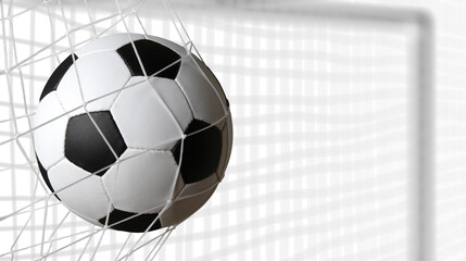 Soccer ball in goal on white