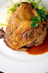 Duck. Prepared in classic French bistro style. Duck rendered in fat until skin is a crispy golden brown. Served with a frisee salad. 