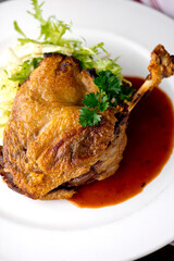 Duck. Prepared in classic French bistro style. Duck rendered in fat until skin is a crispy golden brown. Served with a frisee salad. 