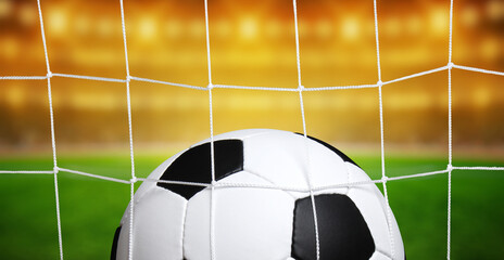 Soccer ball in goal on stadium