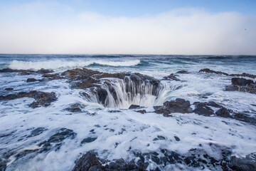 Thor's well, a big round shaped waterfall at the coast in Oregon.