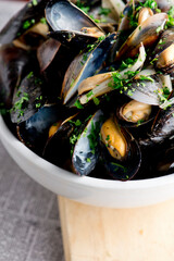 Mussels. Classic French or American restaurant appetizer: steamed mussels. Shellfish steamed with white wine, butter, garlic, onions and fresh herbs. Served with butter toasted baguettes.