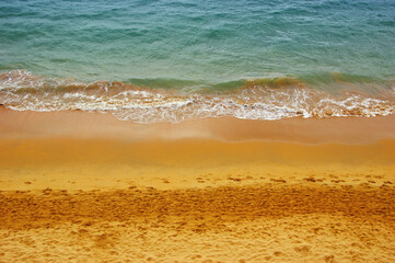 Fototapeta na wymiar Wave of blue ocean on beach.