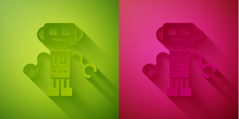 Paper cut Robot toy icon isolated on green and pink background. Paper art style. Vector.