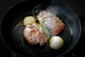 cooking at home - roasted game meat from the chamois buck with onions and rosemary