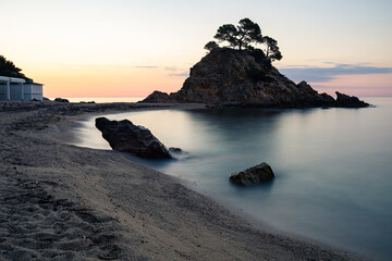 Long exposure view of the Cap Roig point sunrise and the beach of the same name. Catalonia, Spain
