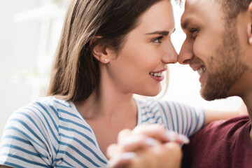 happy beautiful young couple hugging and looking at each other