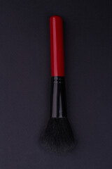 Black makeup brush from top. Close-up thick brush.