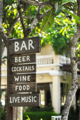 Food and drink wooden sign beside walk way