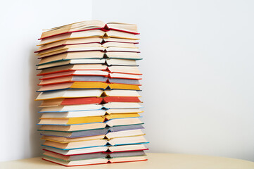 Big stack of colorful open books on table over white background Education study concept Copy space