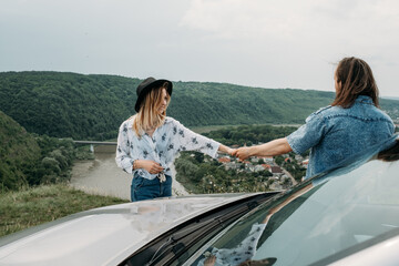 Young Trendy Traveling Couple Having Fun Near the Car on Top of Hill, Travel and Road Trip Concept