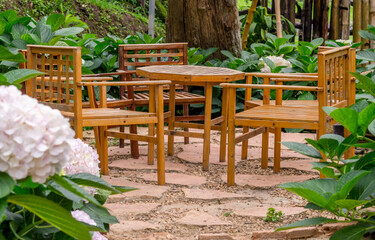 Obraz premium Wood garden chair in hydrangea garden.