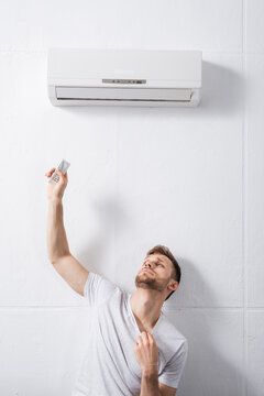 Sad Man Feeling Uncomfortable With Broken Air Conditioner At Home During Summer Heat