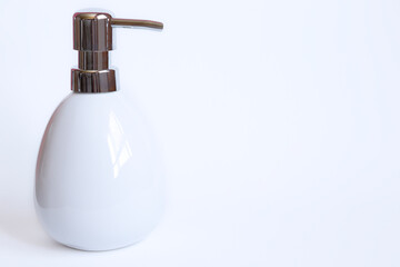 White soap dispenser against white background