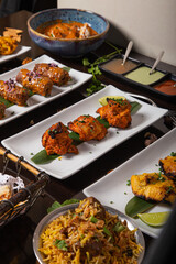 Different dishes of Indian cuisine are served at the table.Vertical Isolated image