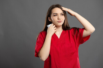 Tired brunette young female nurse is too hot