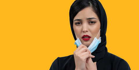 Arab Woman with protective face mask off and breathing fresh air. Concept of taking off the mask....
