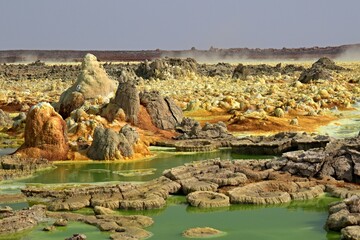 Salt ponds, bubbling chimneys and salt terraces form the bottom of the volcanic crater Dallol,...