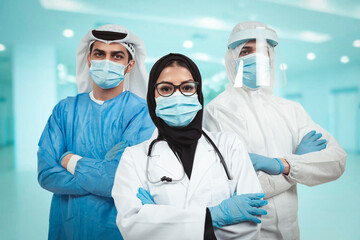 Successful team of Arabic medical doctors are looking at camera while standing in hospital with...