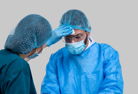 Young surgery team in the operating room, Serious surgeons during a surgery in the hospital. Cross Process. - Powered by Adobe