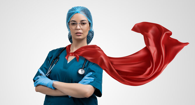 Doctor in superhero cape. Concept of super heroism medical staff during coronavirus outbreak, standing on grey background.