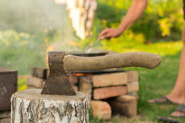 Old ax against a background of green grass