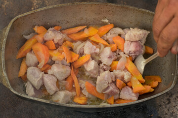 Pilaf in a cauldron with spoon
