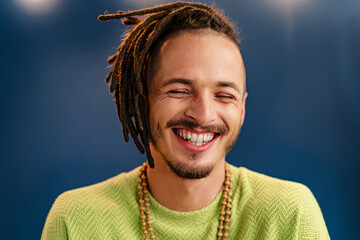 Close-up portrait of a young stylish man with dreadlocks