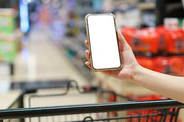 Mockup, hands holding blank white screen mobile phone with shopping cart in supermarket, digital...