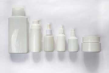Simple Blank white Plastic Cosmetic Bottles Set.set of cosmetic products on a white background. Cosmetic package collection for cream, soups, foams, shampoo. Mock up white cosmetic bottles on white